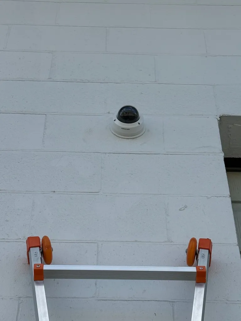 Hikvision vandal-proof dome security camera installed on exterior block wall - Security Installation by AK Security Ltd. Vancouver