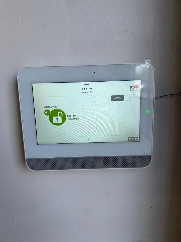 Qolsys IQ Panel touch screen alarm system interface mounted on wall - Security Installation by AK Security Ltd. Vancouver